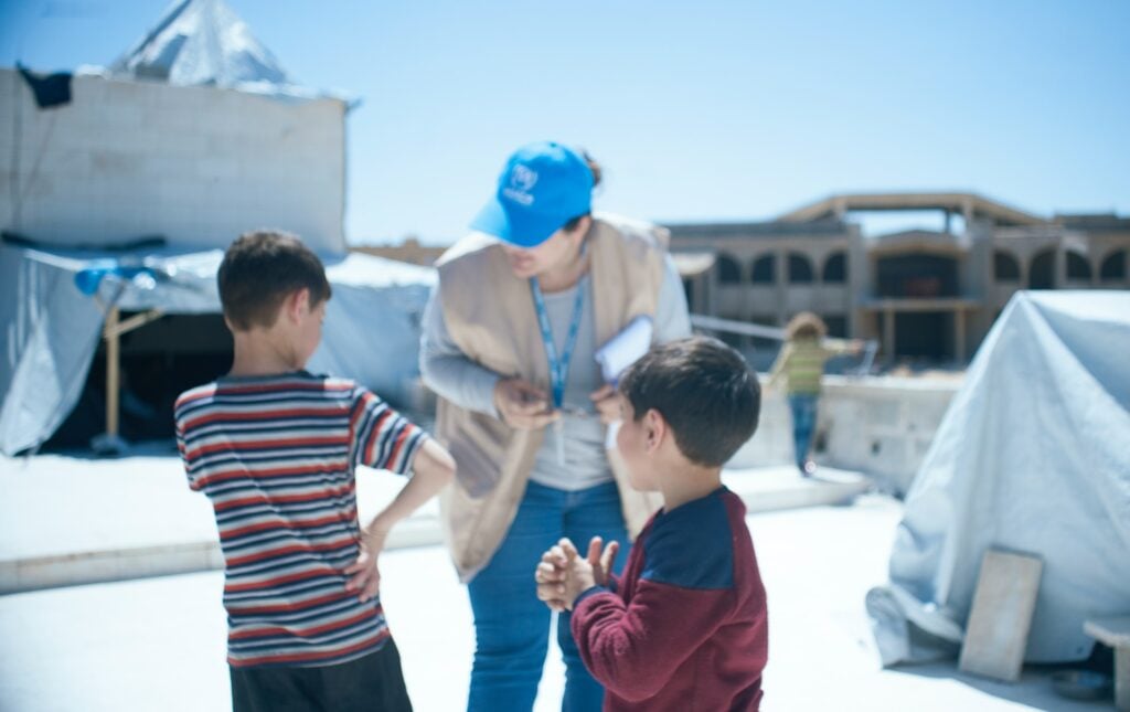Representante da Agência das Nações Unidas para os Refugiados conversa com crianças sírias. 